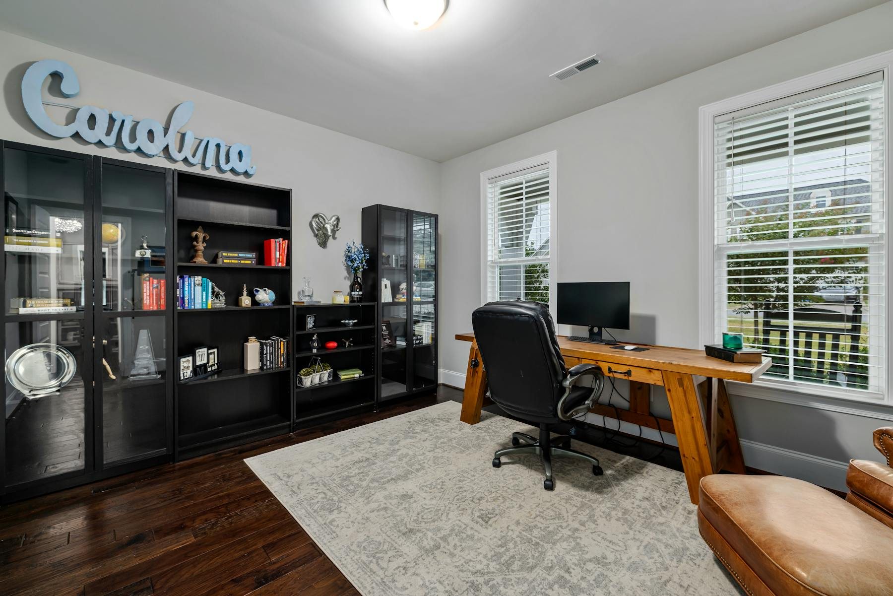 Creative home office nook with desk, shelves, and natural light