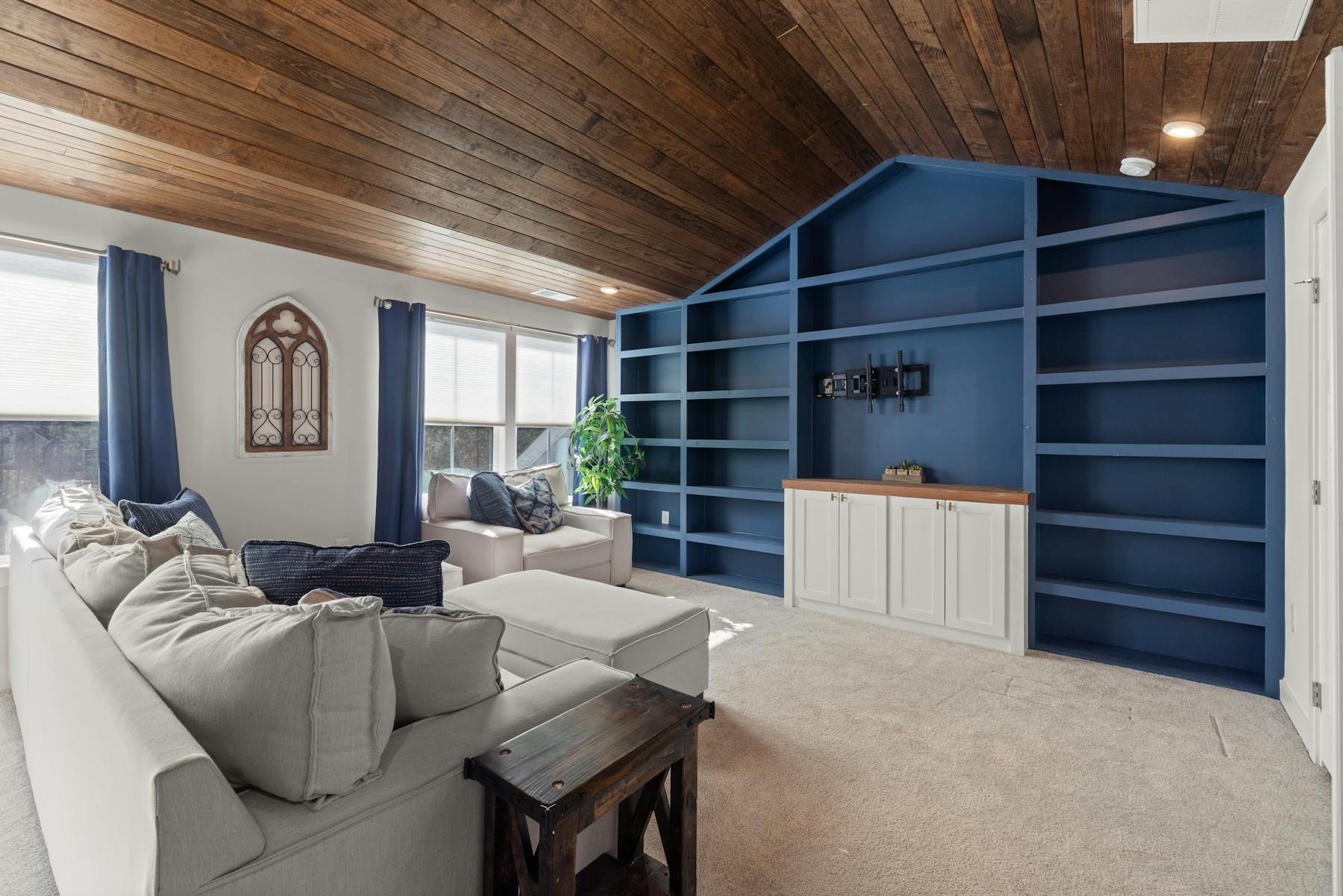 Custom built-in shelving and storage wall in a modern room
