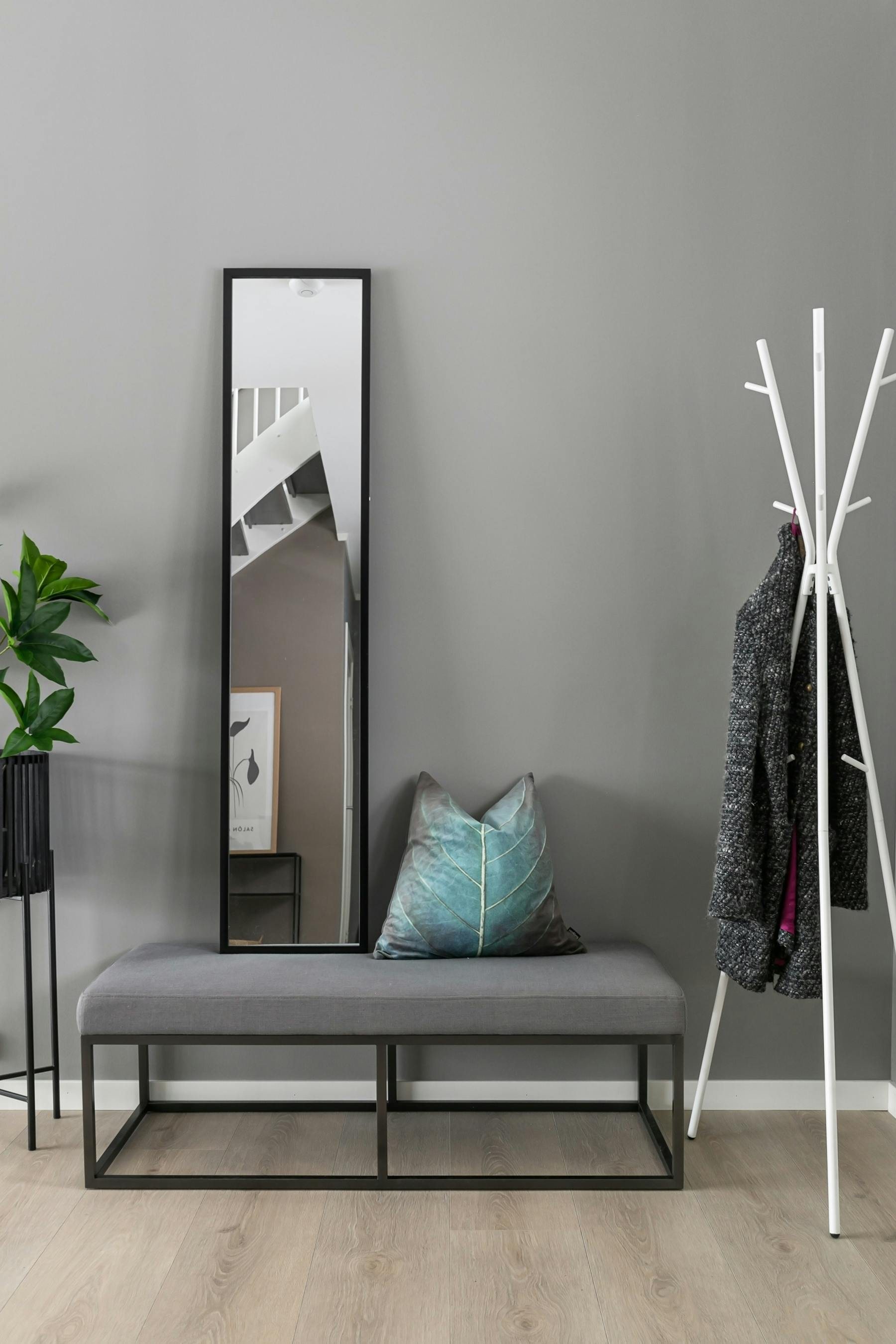 Entryway organizer with wooden bench, hooks, and storage