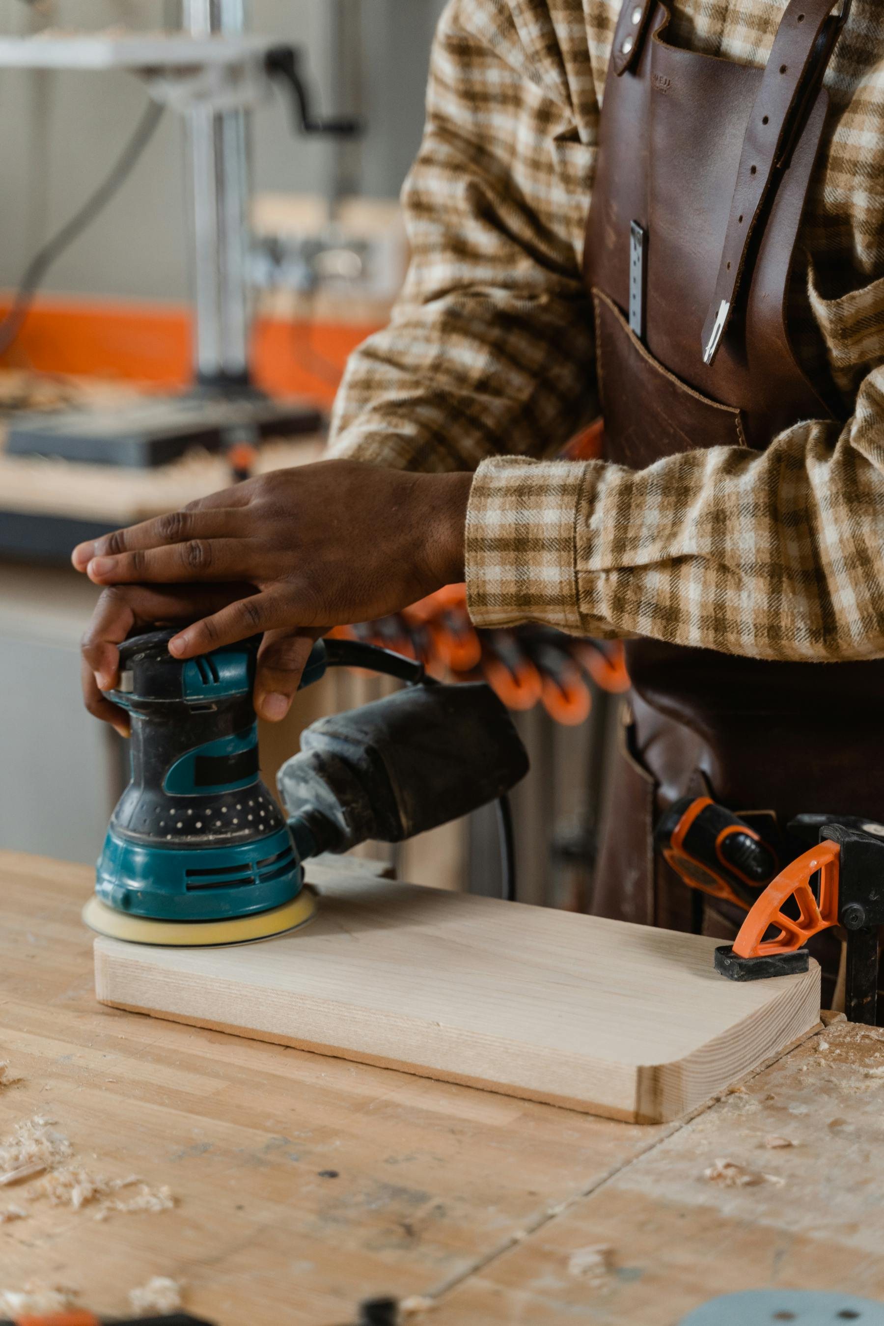 Artisan restoring a wooden chair in a workshop